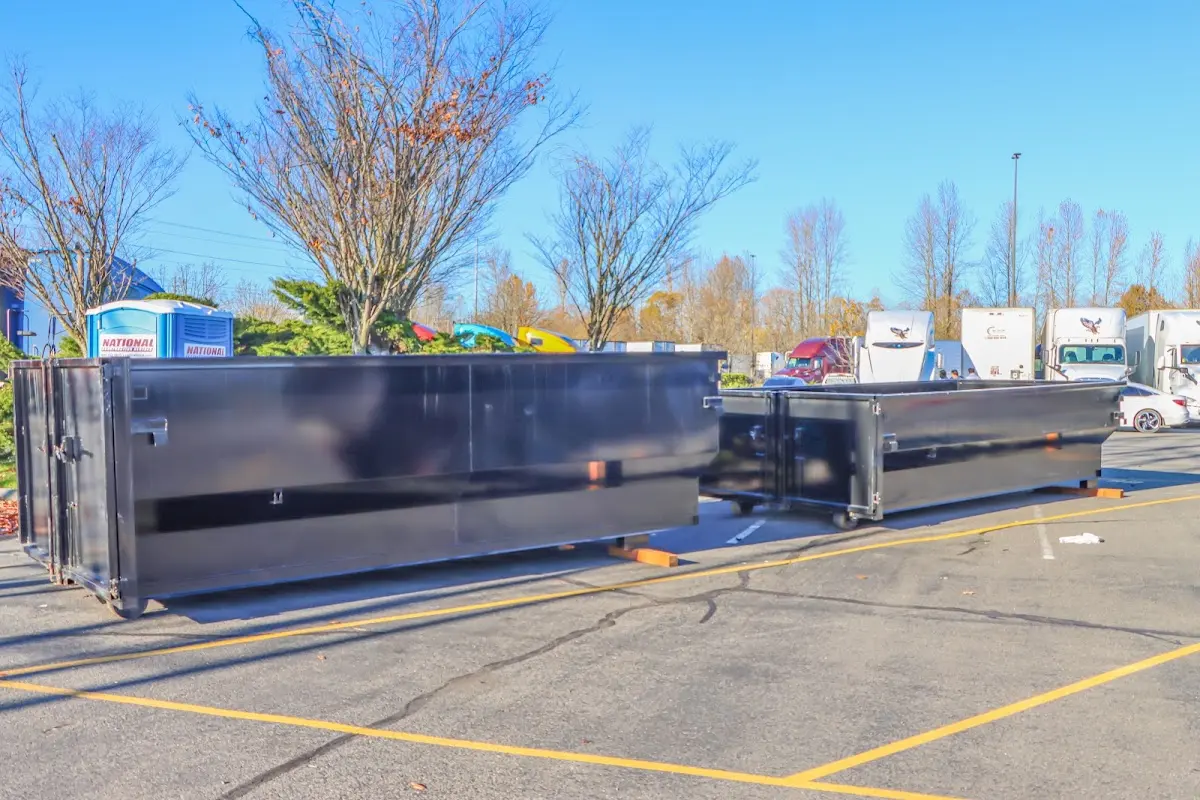 Professional dumpster rental service with roll-off container on residential driveway in Fort Thomas